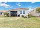 Expansive backyard with a view of the screened lanai, offering a great space for relaxation and recreation at 20389 Minuet Pl, Venice, FL 34293