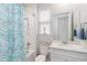 Bathroom with a tub/shower combination, white vanity and decorative mirror at 20389 Minuet Pl, Venice, FL 34293