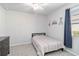 Small bedroom with a twin bed, ceiling fan, and a dresser with light grey walls at 20389 Minuet Pl, Venice, FL 34293