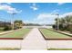 Scenic bocce ball courts with lush green turf and a tranquil lake view, offering a relaxing and enjoyable outdoor experience at 20389 Minuet Pl, Venice, FL 34293