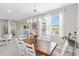 Dining room with a wood table, six chairs, and lots of natural light at 20389 Minuet Pl, Venice, FL 34293
