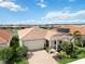 Beautiful home with a brick driveway, well-manicured landscaping, and solar panels on the roof at 20389 Minuet Pl, Venice, FL 34293