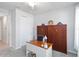 Home office featuring a desk, wooden Murphy bed, closet and neutral walls and carpet at 20389 Minuet Pl, Venice, FL 34293