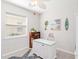 Bright office featuring a desk, comfortable seating, and tropical themed wall decor at 20389 Minuet Pl, Venice, FL 34293