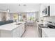 Spacious kitchen featuring a center island, stainless appliances and bright natural light at 20389 Minuet Pl, Venice, FL 34293