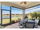 Delight in the serene lake views from this screened-in lanai featuring comfortable seating and lighting at 20389 Minuet Pl, Venice, FL 34293