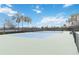 Well-maintained tennis court with vibrant blue and green surfaces, surrounded by lush greenery and providing an active lifestyle at 20389 Minuet Pl, Venice, FL 34293