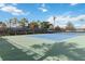 Well-maintained tennis court with vibrant blue and green surfaces, surrounded by lush greenery and providing an active lifestyle at 20389 Minuet Pl, Venice, FL 34293