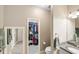 Bathroom featuring a granite-topped vanity, toilet, and a walk-in closet at 2042 Mesic Hammock Way, Venice, FL 34292