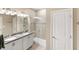 Well-lit bathroom with double vanity, granite counters, and a glass-enclosed shower at 2042 Mesic Hammock Way, Venice, FL 34292