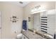 Bright bathroom with a granite countertop vanity and nautical themed decorations at 2042 Mesic Hammock Way, Venice, FL 34292