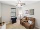 Cozy bedroom featuring a comfortable recliner sofa, neutral tones and a ceiling fan at 2042 Mesic Hammock Way, Venice, FL 34292