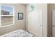 Bright bedroom with a window, closet, and coastal decor at 2042 Mesic Hammock Way, Venice, FL 34292