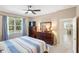 Bedroom features a ceiling fan, large window with natural light, and wood furniture at 2042 Mesic Hammock Way, Venice, FL 34292