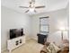 Comfortable bedroom featuring a recliner sofa, neutral tones, and a ceiling fan at 2042 Mesic Hammock Way, Venice, FL 34292