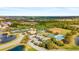 Aerial view of the community center featuring a pool, tennis courts, and green spaces at 2042 Mesic Hammock Way, Venice, FL 34292