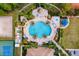 Overhead shot of a luxurious community pool area with palm trees, lounge chairs, and amenities at 2042 Mesic Hammock Way, Venice, FL 34292