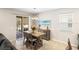 Bright dining area with table, chairs, buffet, beach art, and sliding door to the lanai at 2042 Mesic Hammock Way, Venice, FL 34292