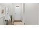 Welcoming entryway featuring tiled floors, decor, and a solid white door with glass panels at 2042 Mesic Hammock Way, Venice, FL 34292