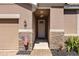 Charming entrance with stone accents leading to the front door, complemented by the lovely landscape at 2042 Mesic Hammock Way, Venice, FL 34292