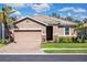 Charming one-story home with a well-manicured lawn, brick driveway, and a two-car garage at 2042 Mesic Hammock Way, Venice, FL 34292