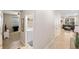 Hallway view of a laundry area, bedroom, and living area, showcasing the home's open layout at 2042 Mesic Hammock Way, Venice, FL 34292