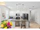 Bright kitchen featuring granite counters, white cabinetry and stainless steel appliances at 2042 Mesic Hammock Way, Venice, FL 34292