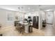 This bright eat-in kitchen features an island, stainless appliances, and granite countertops at 2042 Mesic Hammock Way, Venice, FL 34292
