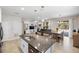 Open-concept kitchen with granite countertops, stainless steel appliances, and a breakfast bar at 2042 Mesic Hammock Way, Venice, FL 34292