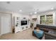 Welcoming living room with tile floors, ceiling fan, and a comfortable sectional sofa at 2042 Mesic Hammock Way, Venice, FL 34292