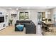 Bright living room featuring a comfortable couch, ceiling fan, and natural light flowing through sliding glass doors at 2042 Mesic Hammock Way, Venice, FL 34292