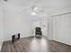 Light-filled bedroom with wood-look flooring, a chair, and a double-door closet at 2114 S Biscayne Dr, North Port, FL 34287