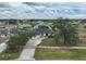 Aerial view of a single-story home showcasing a well-manicured front lawn and a paved driveway at 2114 S Biscayne Dr, North Port, FL 34287