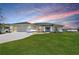 Charming single-story home with a well-manicured lawn, inviting entrance, and attached two-car garage at 2114 S Biscayne Dr, North Port, FL 34287