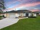 Charming single-story home with well-manicured lawn and two-car garage at 2114 S Biscayne Dr, North Port, FL 34287