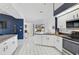 Open kitchen with white cabinets, stainless steel appliances, and tile floors at 2114 S Biscayne Dr, North Port, FL 34287