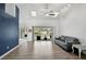Open living room with vaulted ceilings, wood floors, and sliding doors to the pool at 2114 S Biscayne Dr, North Port, FL 34287