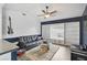 Comfortable living room featuring a ceiling fan, built-in shelving, and natural light at 2114 S Biscayne Dr, North Port, FL 34287