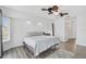 The main bedroom has wood-look floors, a fan, and natural light from the window at 2114 S Biscayne Dr, North Port, FL 34287
