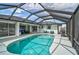A screened in-ground pool offers a serene retreat with ample space for lounging and entertaining at 2114 S Biscayne Dr, North Port, FL 34287
