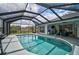 Relax in this screened in-ground pool, ideal for enjoying the outdoors in a private backyard setting at 2114 S Biscayne Dr, North Port, FL 34287