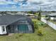 Screened pool and a cozy backyard with a white fence and plenty of seating at 2114 S Biscayne Dr, North Port, FL 34287