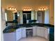 Bathroom featuring dual sinks, white cabinets, and a seated vanity area at 213 Bayside Ct, Nokomis, FL 34275