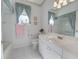 Bright bathroom featuring a large mirror, vanity, and coordinated decor at 213 Bayside Ct, Nokomis, FL 34275
