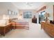 Bedroom featuring neutral tones, wood furniture, and a sliding glass door at 213 Bayside Ct, Nokomis, FL 34275