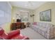 Inviting bedroom features a cozy sofa and well-lit workspace, ideal for a guest room or home office at 213 Bayside Ct, Nokomis, FL 34275