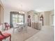 Charming dining room with a round table, natural light, and classic grandfather clock at 213 Bayside Ct, Nokomis, FL 34275