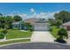 Charming home boasts lush landscaping, a well-manicured lawn, and a welcoming two-car garage at 213 Bayside Ct, Nokomis, FL 34275