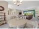 Connected dining and living room, with view into the pool area through large window at 213 Bayside Ct, Nokomis, FL 34275
