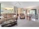 Open-concept living area with comfortable seating and adjacent dining space at 213 Bayside Ct, Nokomis, FL 34275